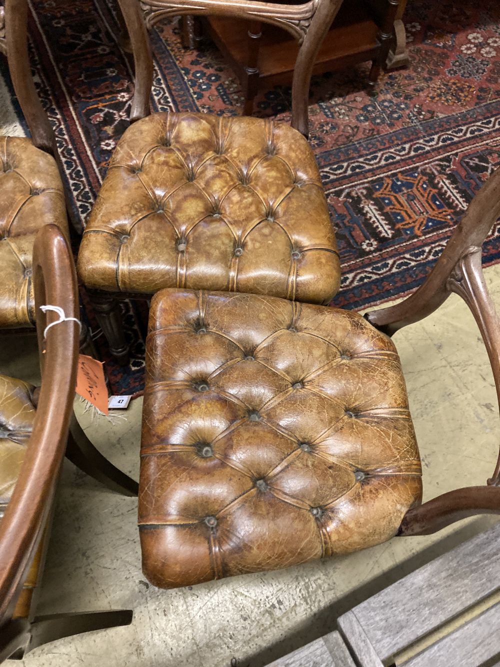 A set of six early Victorian mahogany dining chairs, with buttoned leather seats